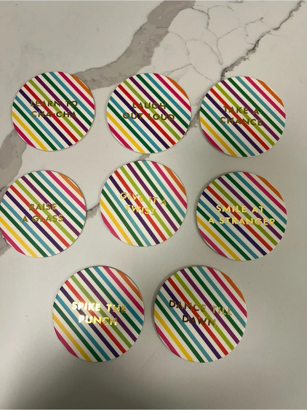 Brand new. Kate Spade Coaster set. Brightly striped with festive & fun sayings.